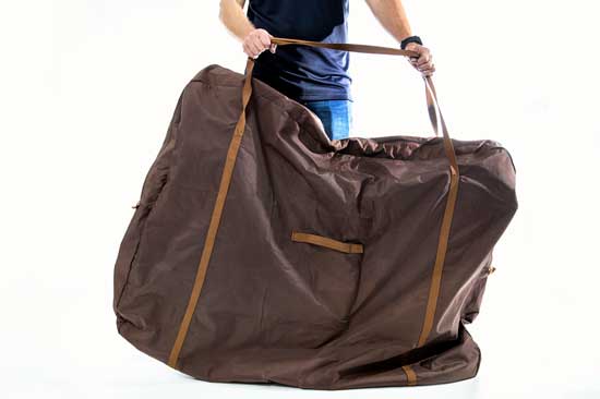 bicycle packed into a bag carried by a male individual